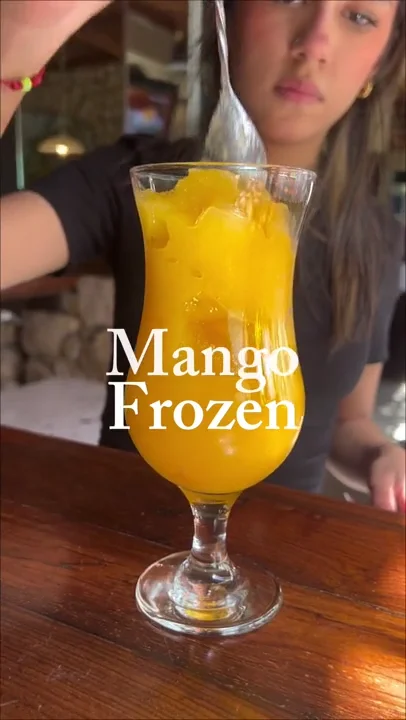 Sofia mixing a mango smoothie at the bar