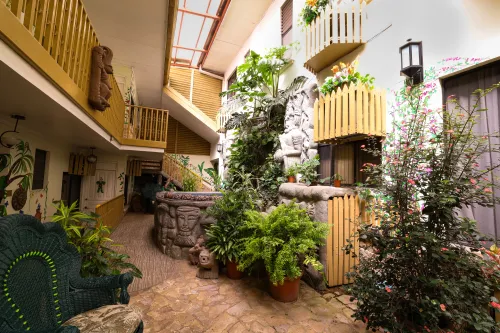 Skylit indoor atrium—Mayan-style stone carvings, murals, and tropical planting.