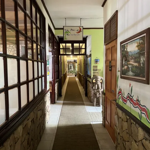 Hallway outside Moon Glow with folk art and tropical planting.