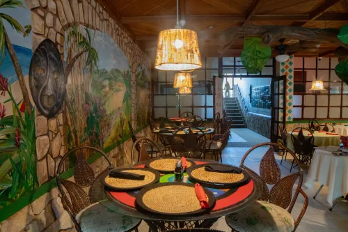 Mural-lined walls and dining tables in Moon Glow.