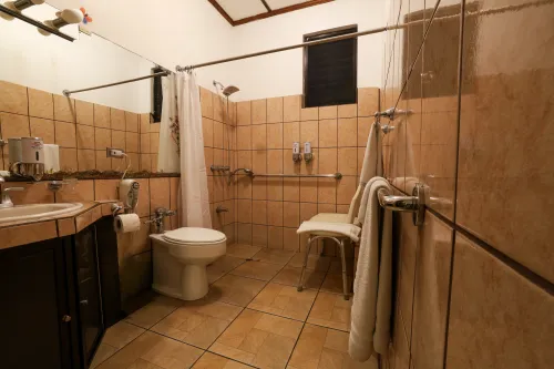 Accessible bathroom with grab bars and roll-in shower.