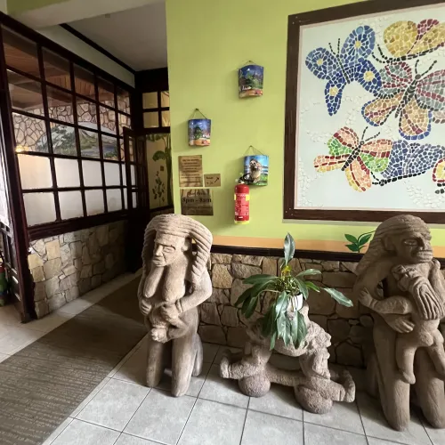 Indigenous stone figures along a hotel hallway.